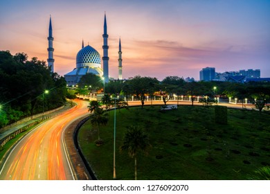 Sunrise scene of light trails of car on the road into Blue Mosque or Sultan Salahuddin Abdul Aziz Shah Mosque location at Shah Alam Selangor near Kuala Lumpur, Malaysia.