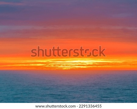 Sunrise seascape with cloud covered sky at Shelly Beach on the Central Coast, NSW, Australia.