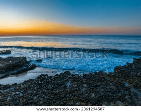 Sunrise seascape with tessellated rock platform at North Avoca on the Central Coast, NSW, Australia.
