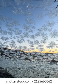 Sunrise Seen Through A Frozen Car Windshield