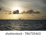 Sunrise sky at deep sea with silhouette offshore platform on the background.