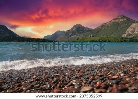 Sunrise sky glowing over Driftwood Beach at Waterton Lakes Park
