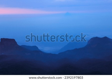 The sunrise sky and the morning mist at the Adam's Peak, Sri Lanka. Background image with copy space for text