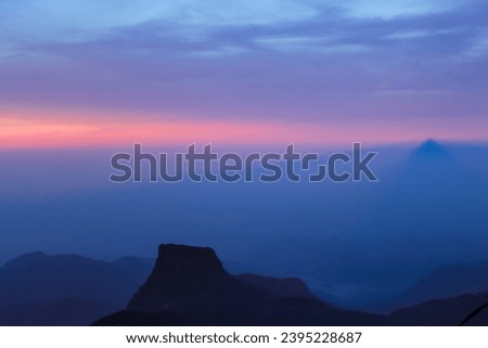 The sunrise sky and the morning mist at the Adam's Peak, Sri Lanka. Background image with copy space for text