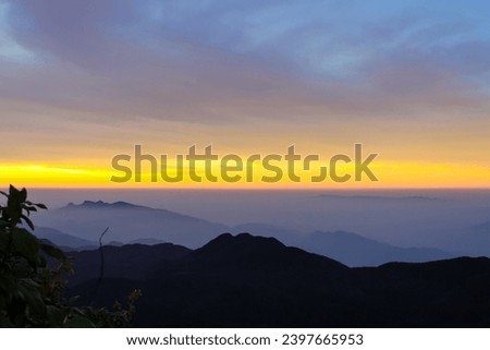 The sunrise sky and the morning mist at the Adam's Peak, Sri Lanka. Background image with copy space for text
