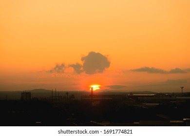 Sunrise At Small Town Sunset Against The Silhouette Of The City