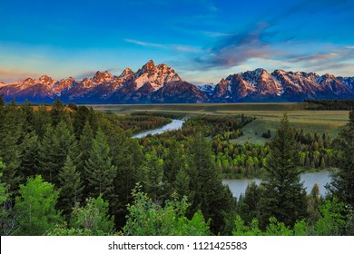 Sunrise From The Snake River Overlook In Wyoming With The Grand Tetons In The Background.