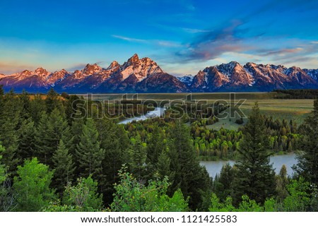 Sunrise from the Snake River Overlook in Wyoming with the Grand Tetons in the background.
