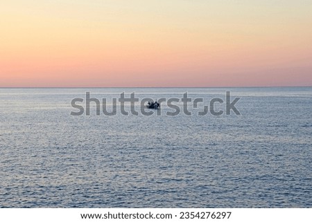 Sunrise with soft color with a fishingboat