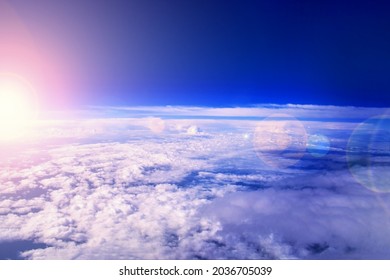 Sunrise in the stratosphere above the clouds. Flying above the clouds in the morning sunlight.