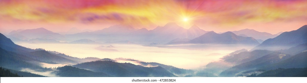  sunrise, the sun's rays illuminate the beautiful panorama of the Carpathian village against backdrop of scenic mountains, where the highlanders live Hutsul. Wild forests, fields pastures - Shutterstock ID 472853824