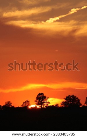 Sunrise sunset intense aflame magnificent red gold orange pink black silhouette Africa USA Midwest bright light Illinois Indiana nature creation faith hope the heavens declare the glory of God majesty