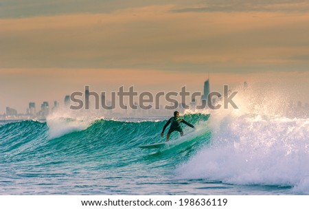 Sunrise Surf with Surfers Paradise on the Background