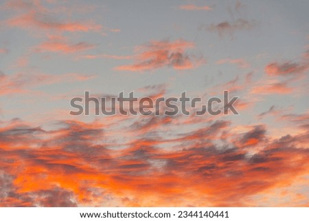 The sunrise and textured altocumulus clouds with shadows and red light in the morning