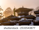 The sunrise through fog at the Dochula Pass Tibetan Buddhist Stupas Chorten in the Himalayas of Bhutan