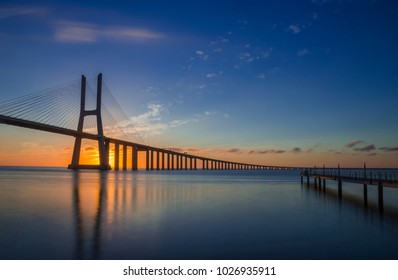 Sunrise at Vasco da Gama Bridge, the longest bridge in Europe, who spans the Tagus River in Lisbon, Portugal.  - Shutterstock ID 1026935911