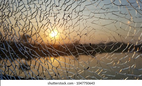 Sunrise View From Cracked Window Glass.