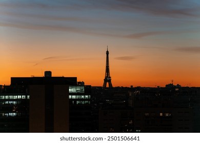 Sunrise View of Eiffel Tower and regency Tower against Golden Hour orange Sky in Paris morning