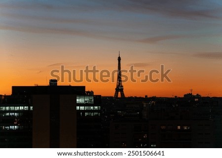 Sunrise View of Eiffel Tower and regency Tower against Golden Hour orange Sky in Paris morning