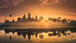 Sunrise View Of Popular Tourist Attraction Ancient Temple Complex Angkor Wat With Reflected In Lake Siem Reap, Cambodia