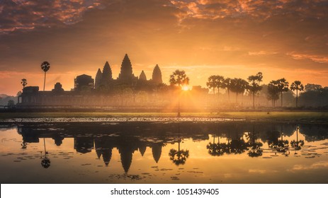 Sunrise view of popular tourist attraction ancient temple complex Angkor Wat with reflected in lake Siem Reap, Cambodia - Powered by Shutterstock