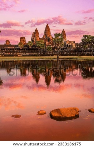 Sunrise view of popular tourist attraction ancient temple complex Angkor Wat with reflection in Siem Reap lake, Cambodia