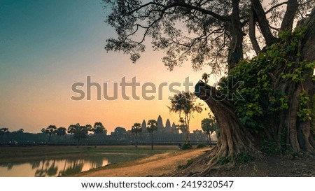 Sunrise view of popular tourist attraction ancient temple complex Angkor Wat with reflected in lake Siem Reap, Cambodia

