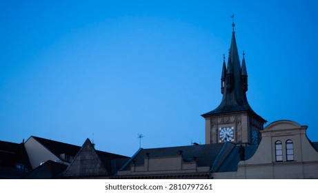 Sunrise view of Prague rooftops and Clock tower