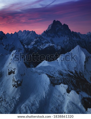 Sunrise view of the snow-capped mountains from rifugio Lagazuoi, Dolomites, Italy. Winter dawn in the mountains, the surroundings of Cortina d'Ampezzo. Morning mountain landscape, the Alps.