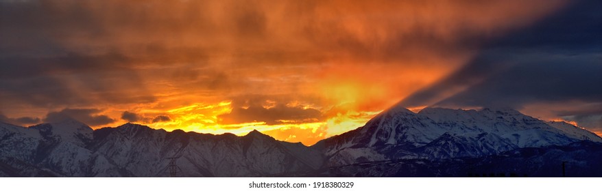Sunrise view of winter panorama. Snow capped Mt Timpanogos in the Wasatch Front Rocky Mountains, Great Salt Lake Valley and Cloudscape. Provo, Utah, United States.