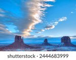 Sunrise, West Mitten Butte on left, East Mitten Butte in centre and Merrick Butte on right, Monument Valley Navajo Tribal Park, Utah, United States of America, North America