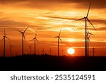 Sunrise at a wind farm power plant.