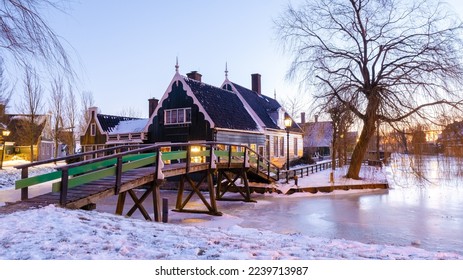 sunrise at the windmill village Zaanse Schans during winter with snow landscape in the Netherlands Holland village in winter - Powered by Shutterstock