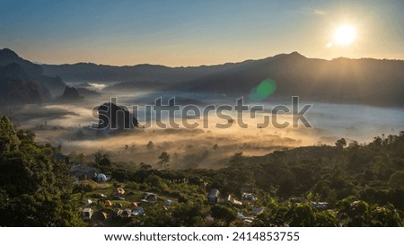Sunrise Winther on Holliday People Camping for sea ​​of ​​fog in the morning at National Park, Phayao province in Thailand.