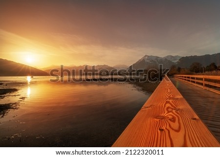 Sunrise with a wooden pier in switzerland