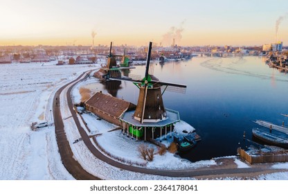 sunrise at the Zaanse Schans Netherlands a Dutch windmill village during winter, drone aerial view at the historical wind mills of the Zaanse Schans Zaandam - Powered by Shutterstock