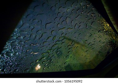 Sunroof Open From A Car During A Rainy Night Creating Water Drops On The Glass 