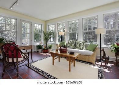 Sunroom In Suburban Home With Red Brick Flooring