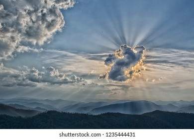 The sun's rays behind the cloud