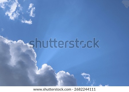 The sun's rays break through the clouds. A beautiful sky background.