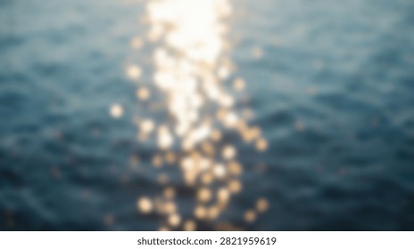 The suns rays create a dazzling display of light on the rippling surface of the deep blue ocean water.