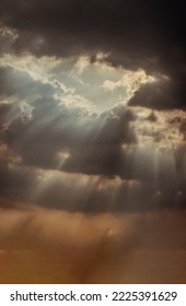 The sun's rays passing through the clouds and shining form an interesting light pattern against the sky. Space for text, Selective focus. - Shutterstock ID 2225391629