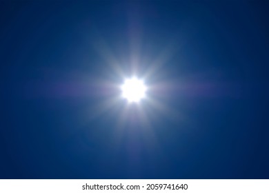 The sun's rays spreading across the cloudless sky