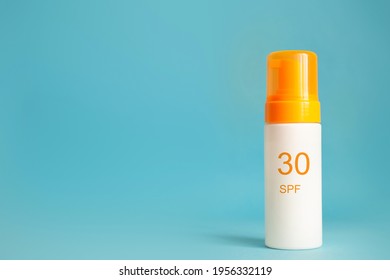 Sunscreen Bottle With Spf 30 Cream Or Lotion On The Aqua Blue Background With Copy Space. Sun Protection, Sunblock, Uv Cosmetic.