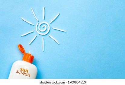 Sunscreen. Cream in the form of sun on blue background with white tube. Copy space for text.