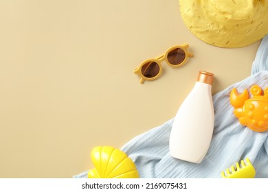 Sunscreen Lotion Bottle, Baby Sunglasses, Panama Hat, Towel, Sand Molds On Beige Background. Kids Summer Vacation Concept.