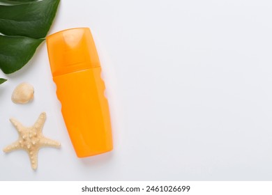 Sunscreen lotion with summer decor on color background, top view - Powered by Shutterstock