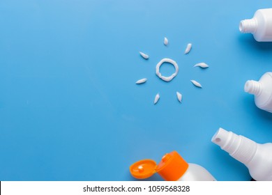 Sunscreen on blue background. relax on the beach concept