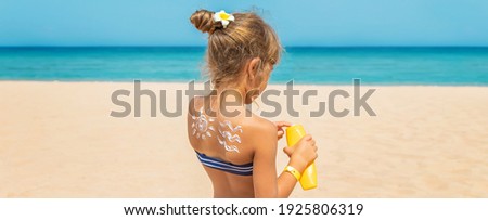 Sunscreen on the skin of a child. Selective focus. nature.