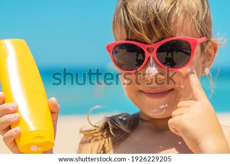 Sunscreen on the skin of a child. Selective focus. nature.
